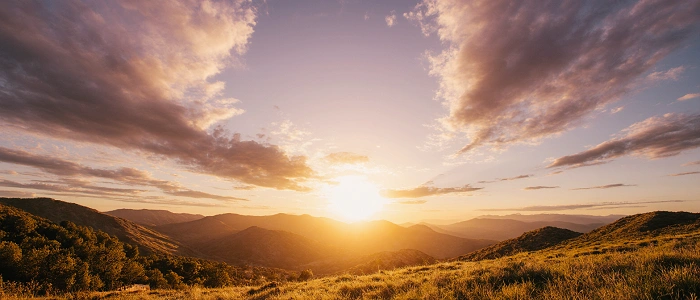 Letní slunovrat nad horskou krajinou zalitou zlatým světlem jako symbol geocachingového suvenýru June Solstice 2026