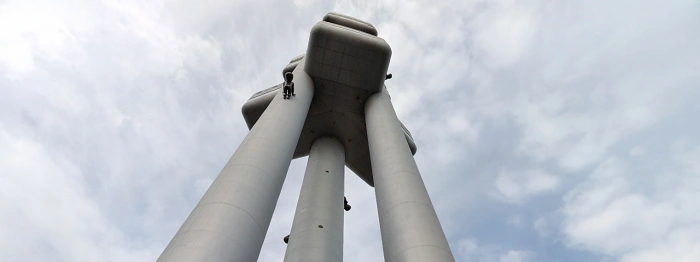 Pohled zdola na Žižkovskou věž s instalací miminek od Davida Černého.